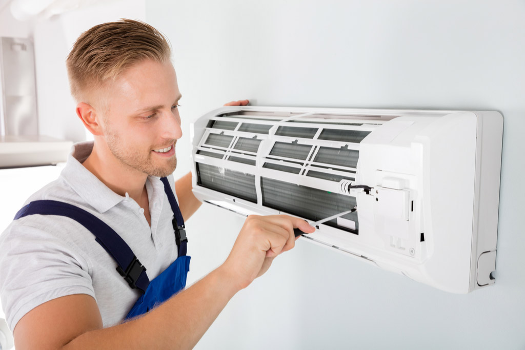 HVAC technician maintaining a ductless air conditioner in Downey