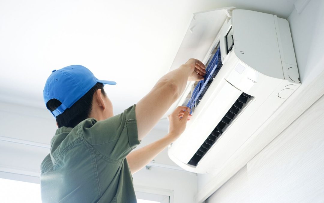 HVAC technician servicing a ductless mini split in Downey