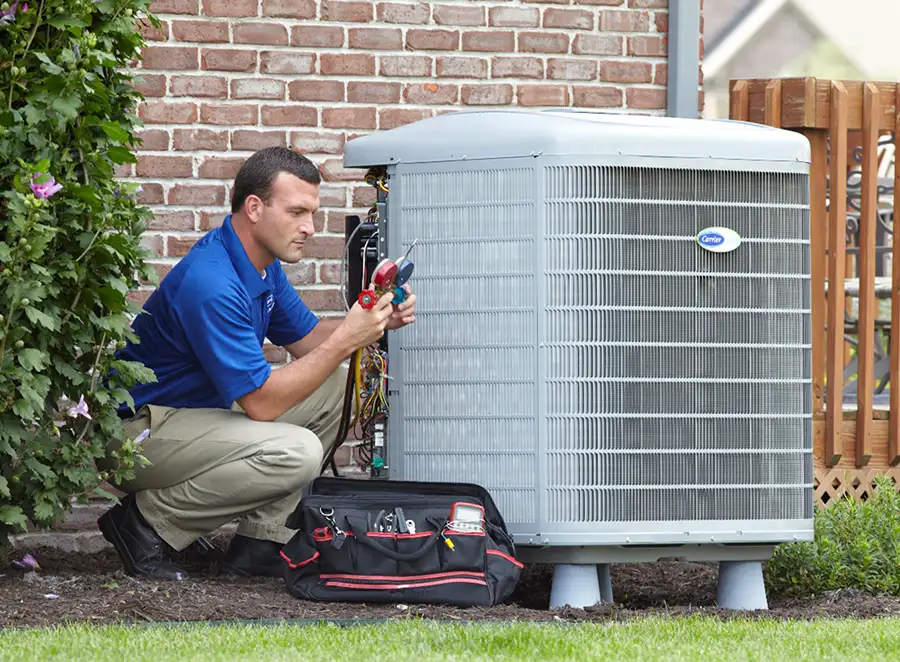 HVAC technician inspecting an outdoor AC unit in Downey